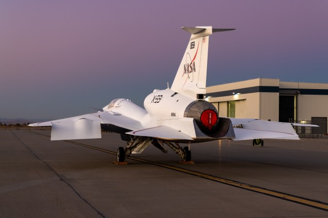 NASA's X-59 sits parked outside its hangar.