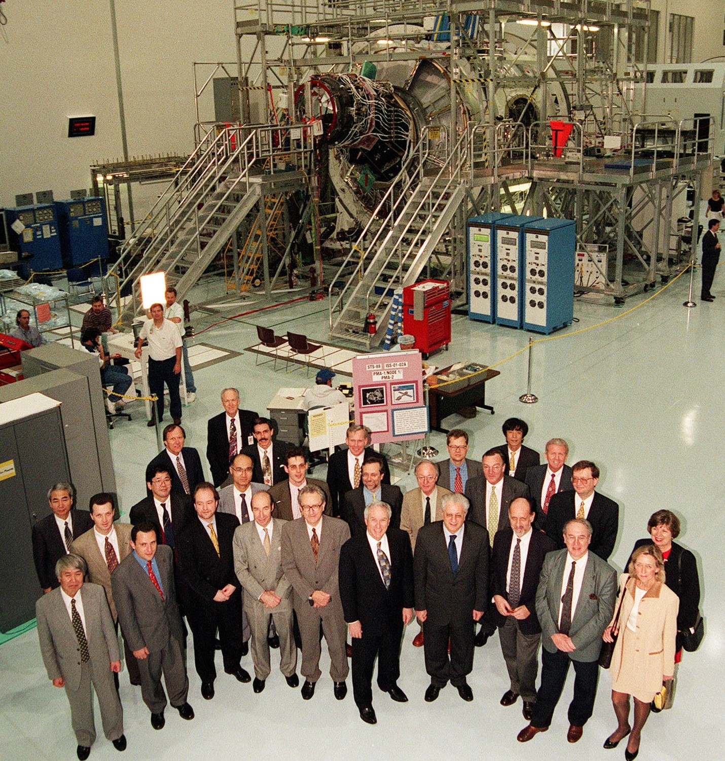 Signatories of the 1998 Intergovernmental Agreement visit the Space Station Processing Facility at NASA’s Kennedy Space Center in Florida, and pose in front of the Unity Node 1 module being prepared for launch