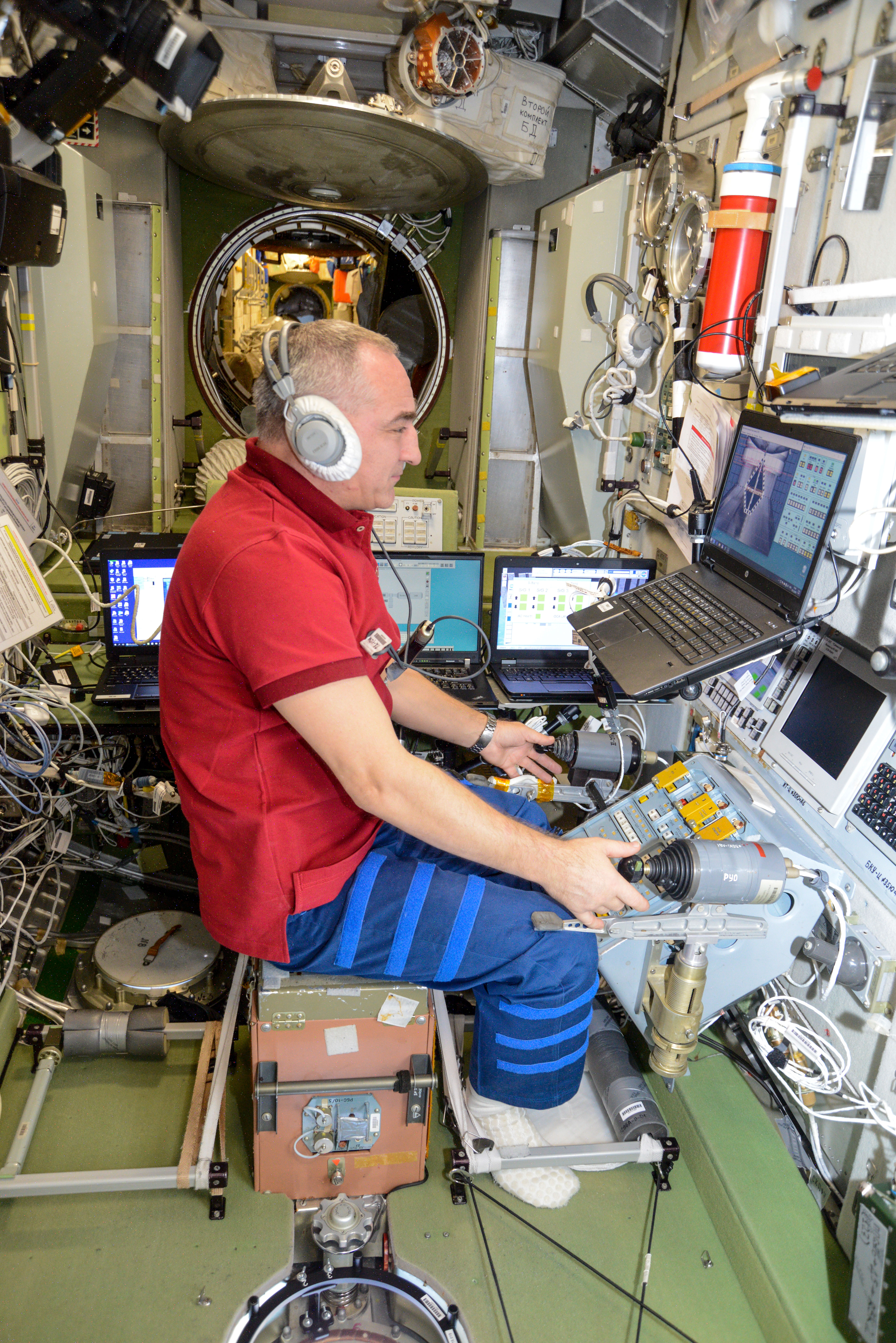 Roscosmos cosmonaut Alexander Skvortsov trains on a computer inside the Zvezda service module for the unlikely scenario he would need to telerobotically maneuver a Russian cargo craft to a docking port on the International Space Station.