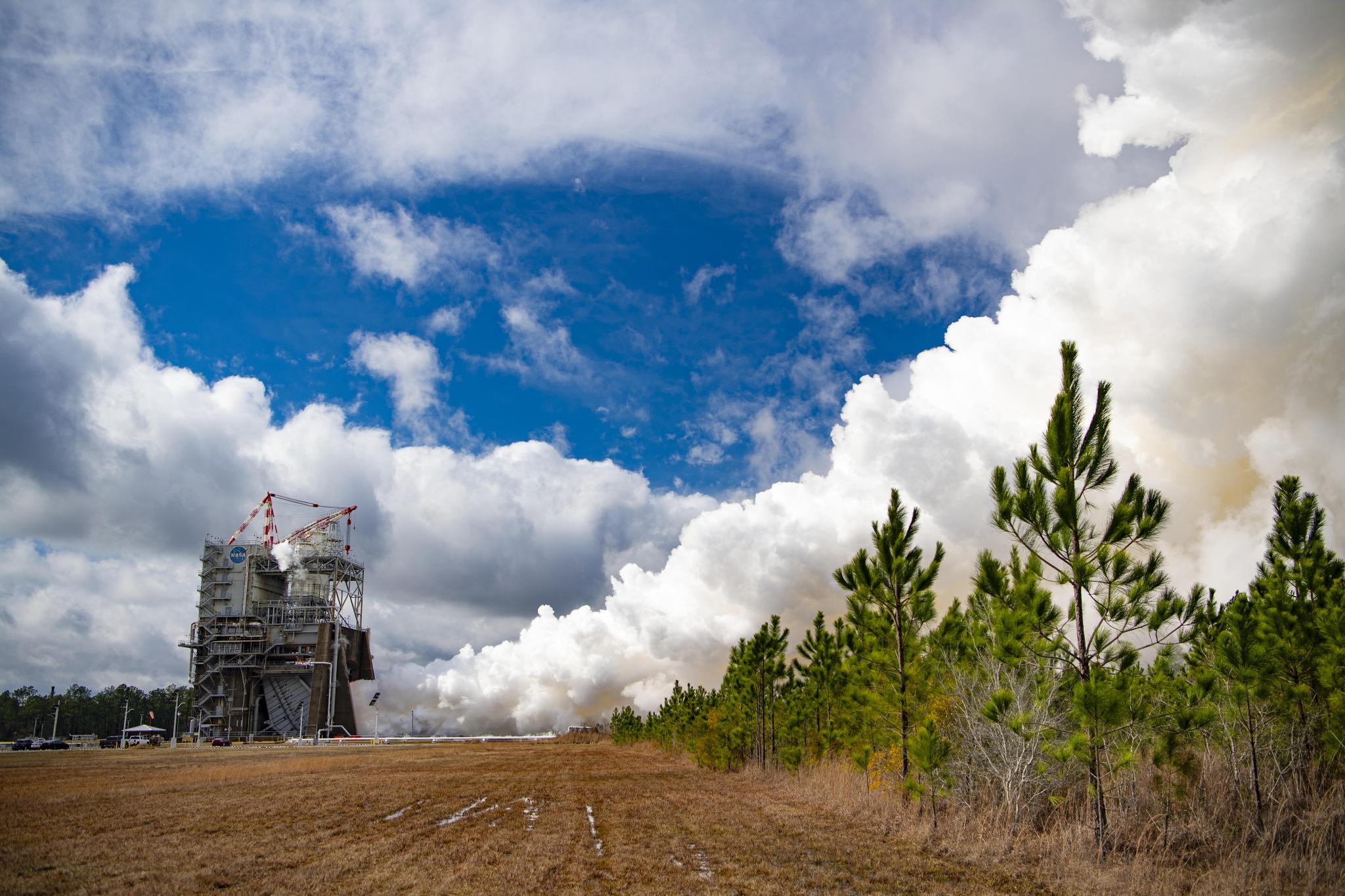 a full-duration, 500-second hot fire of an RS-25 certification engine Jan. 27 in the background as seen across an empty field