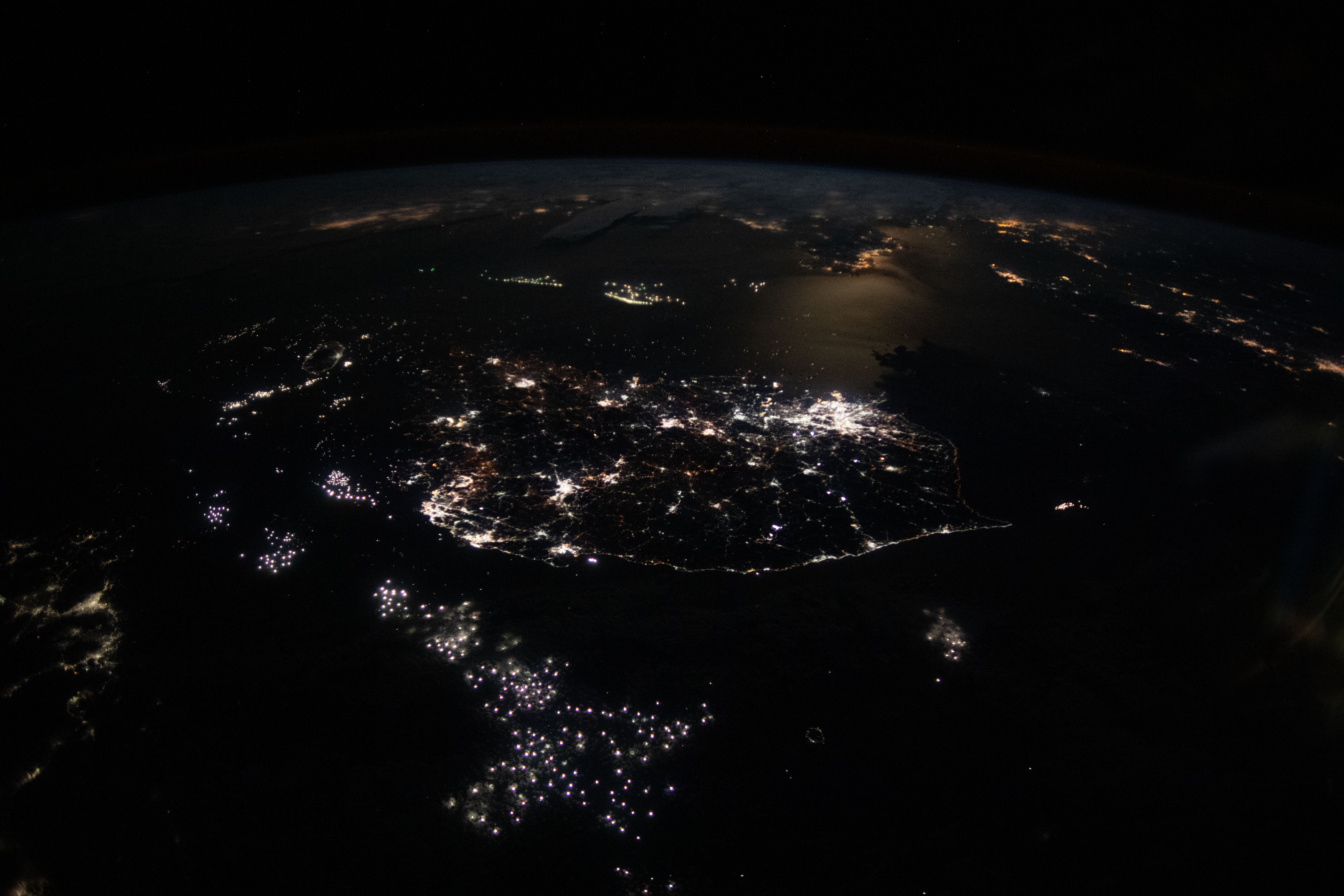 The lights of South Korean cities and fishing boats on the Sea of Japan and the Yellow Sea are pictured as the International Space Station orbited 260 miles in altitude off the coast of Japan near Hiroshima. The brightest city lights toward the center represent the South Korean capital city of Seoul.