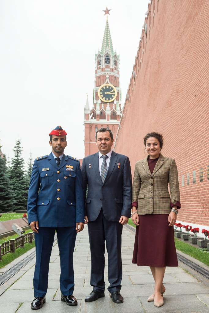 At the Kremlin Wall in Red Square in Moscow, spaceflight participant Hazzaa Ali Almansoori of the United Arab Emirates (left) and Expedition 61 crewmembers Oleg Skripochka of Roscosmos (center) and Jessica Meir of NASA (right) pose for pictures Sept. 5 after laying flowers at the Wall where Russian space icons are interred. They will launch Sept. 25 from the Baikonur Cosmodrome in Kazakhstan on the Soyuz MS-15 spacecraft for a mission on the International Space Station. Image: Andrey Shelepin/Gagarin Cosmonaut Training Center.