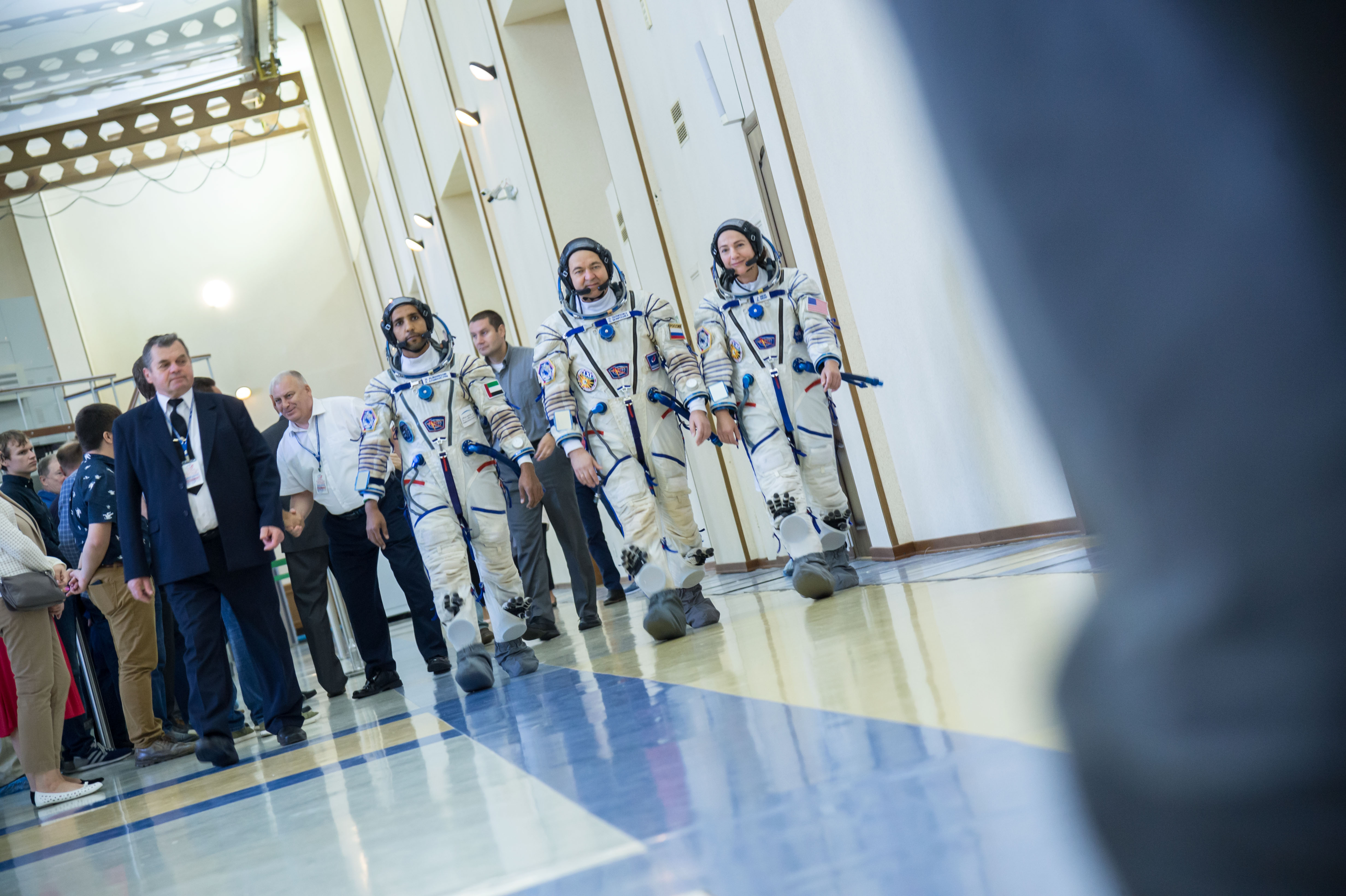 At the Gagarin Cosmonaut Training Center in Star City, Russia, spaceflight participant Hazzaa Ali Almansoori of the United Arab Emirates (left), Oleg Skripochka of Roscosmos (center) and Jessica Meir of NASA (right) report for duty on the second day of crew qualification exams Aug. 30. They will launch Sept. 25 on the Soyuz MS-15 spacecraft from the Baikonur Cosmodrome in Kazakhstan for a mission on the International Space Station.