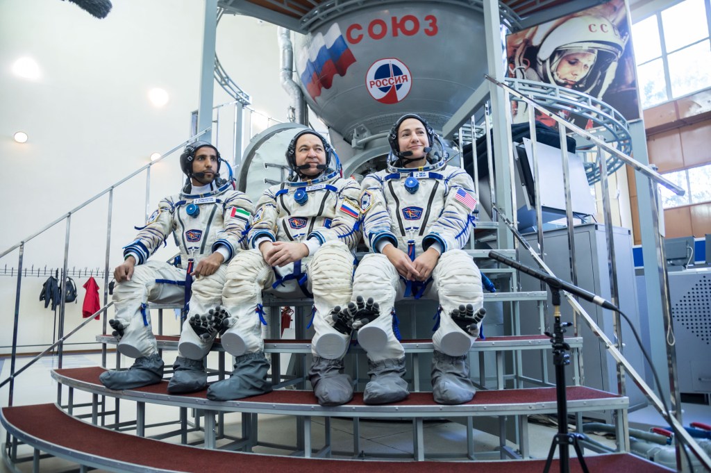 At the Gagarin Cosmonaut Training Center in Star City, Russia, spaceflight participant Hazzaa Ali Almansoori of the United Arab Emirates (left), Oleg Skripochka of Roscosmos (center) and Jessica Meir of NASA (right) listen to reporters’ questions Aug. 30 during crew qualification exams. They will launch Sept. 25 on the Soyuz MS-15 spacecraft from the Baikonur Cosmodrome in Kazakhstan for a mission on the International Space Station.