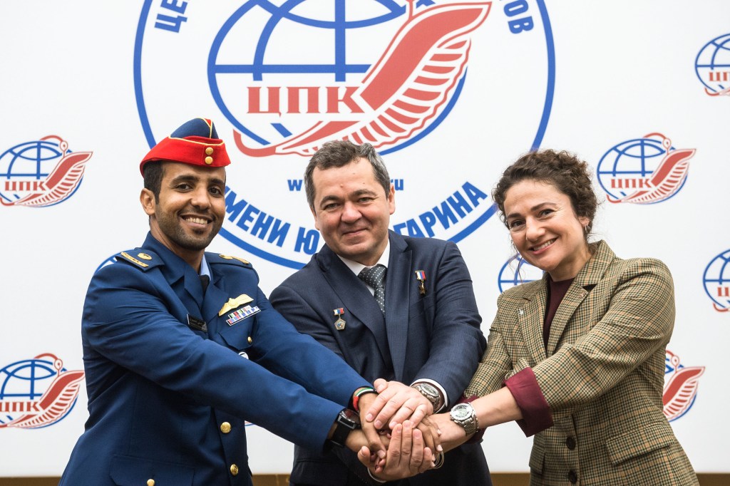 At the Gagarin Cosmonaut Training Center in Star City, Russia, spaceflight participant Hazzaa Ali Almansoori of the United Arab Emirates (left), Oleg Skripochka of Roscosmos (center) and Jessica Meir of NASA (right) pose for pictures Sept. 5 as part of a pre-flight news conference. They will launch Sept. 25 from the Baikonur Cosmodrome in Kazakhstan on the Soyuz MS-15 spacecraft for a mission on the International Space Station.