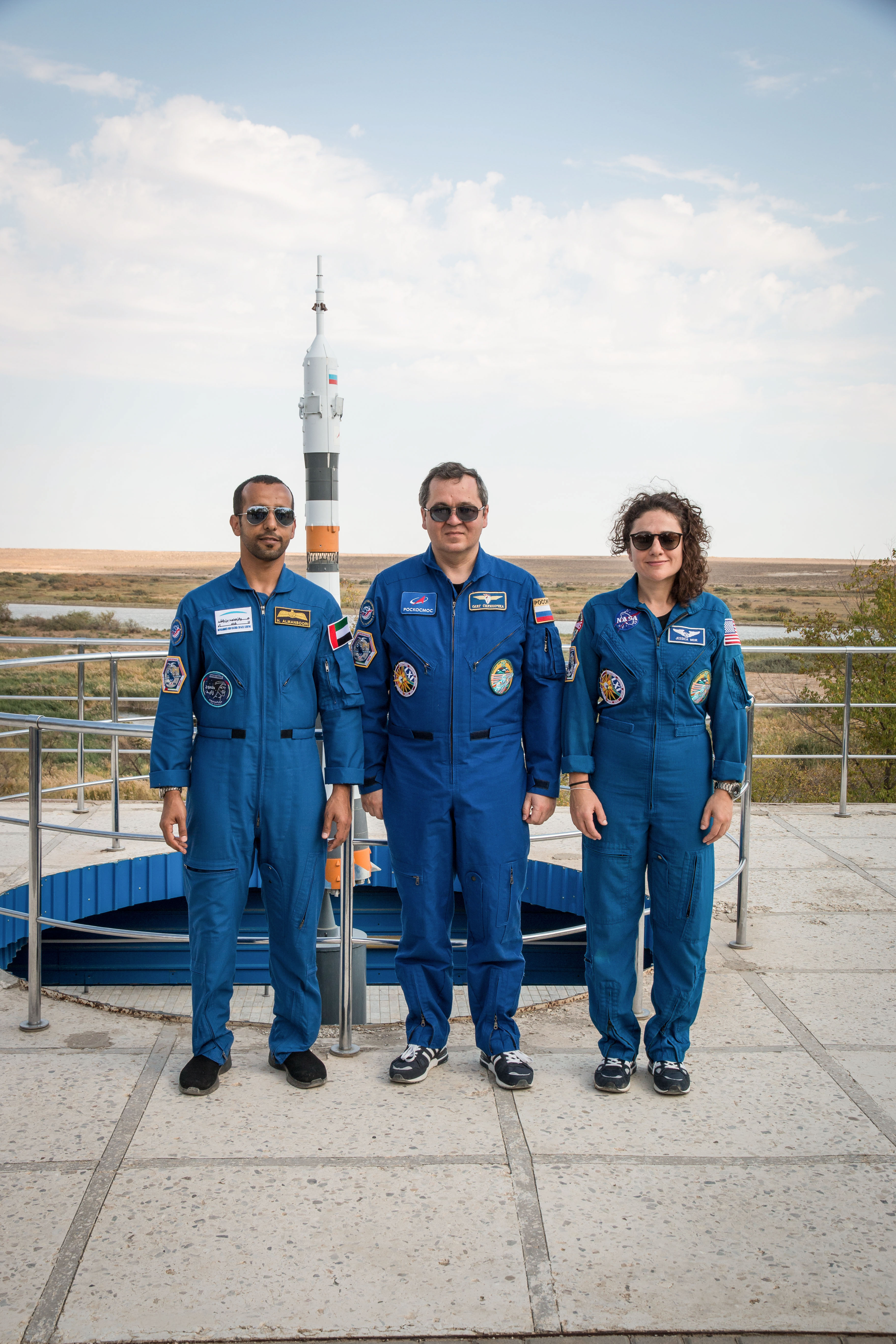 At the Cosmonaut Hotel crew quarters in Baikonur, Kazakhstan, spaceflight participant Hazzaa Ali Almansoori of the United Arab Emirates (left) and Expedition 61 crewmembers Oleg Skripochka of Roscosmos (center) and Jessica Meir of NASA (right) pose for pictures Sept. 18 as part of pre-launch activities. They will launch Sept. 25 from the Baikonur Cosmodrome in Kazakhstan on the Soyuz MS-15 spacecraft for a mission on the International Space Station.