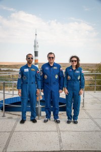 At the Cosmonaut Hotel crew quarters in Baikonur, Kazakhstan, spaceflight participant Hazzaa Ali Almansoori of the United Arab Emirates (left) and Expedition 61 crewmembers Oleg Skripochka of Roscosmos (center) and Jessica Meir of NASA (right) pose for pictures Sept. 18 as part of pre-launch activities. They will launch Sept. 25 from the Baikonur Cosmodrome in Kazakhstan on the Soyuz MS-15 spacecraft for a mission on the International Space Station.