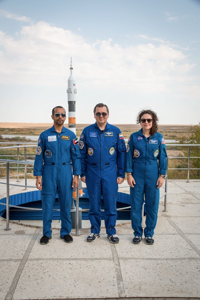 At the Cosmonaut Hotel crew quarters in Baikonur, Kazakhstan, spaceflight participant Hazzaa Ali Almansoori of the United Arab Emirates (left) and Expedition 61 crewmembers Oleg Skripochka of Roscosmos (center) and Jessica Meir of NASA (right) pose for pictures Sept. 18 as part of pre-launch activities. They will launch Sept. 25 from the Baikonur Cosmodrome in Kazakhstan on the Soyuz MS-15 spacecraft for a mission on the International Space Station.