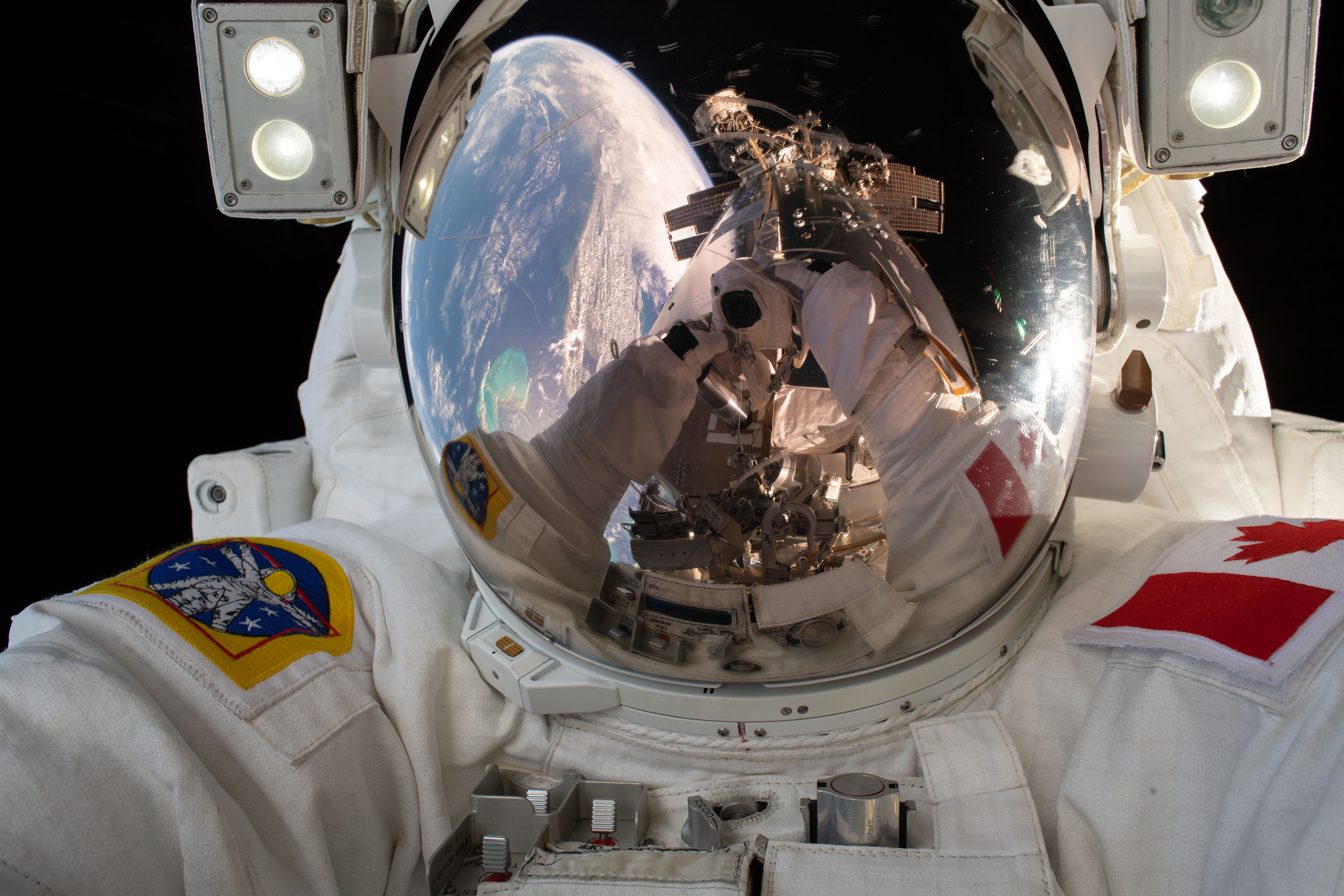 Expedition 59 Flight Engineer David Saint-Jacques of the Canadian Space Agency takes a quick self portrait while working outside the International Space Station. In a six and a half hour spacewalk, Saint-Jacques and NASA astronaut Anne McClain successfully established a redundant path of power to the Canadian-built robotic arm, known as Canadarm2, and installed cables to provide for more expansive wireless communications coverage outside the orbital complex, as well as for enhanced hardwired computer network capability. The duo also relocated an adapter plate from the first spacewalk in preparation for future battery upgrade operations.
