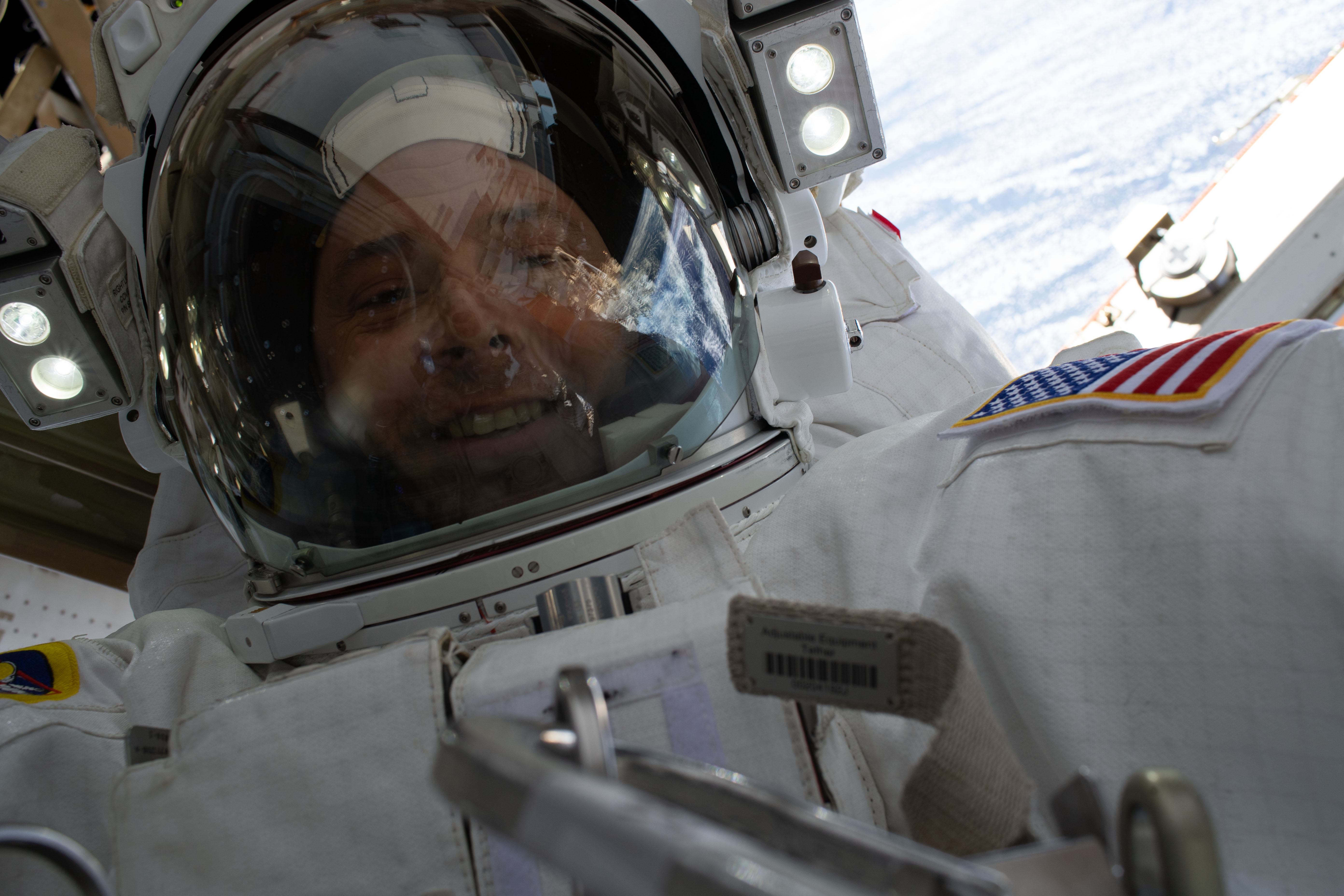 NASA astronaut Nick Hague takes a "space-selfie" with his helmet visor up and the Earth 260 miles below him during a six-hour, 45-minute spacewalk to upgrade the orbital complex's power storage capacity.