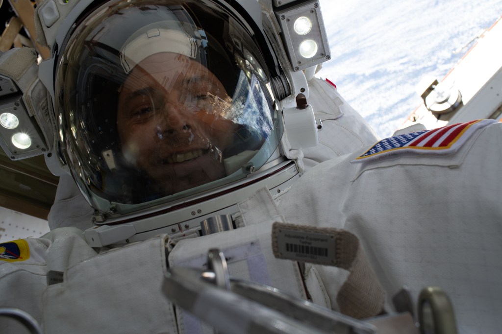 NASA astronaut Nick Hague takes a "space-selfie" with his helmet visor up and the Earth 260 miles below him during a six-hour, 45-minute spacewalk to upgrade the orbital complex's power storage capacity.