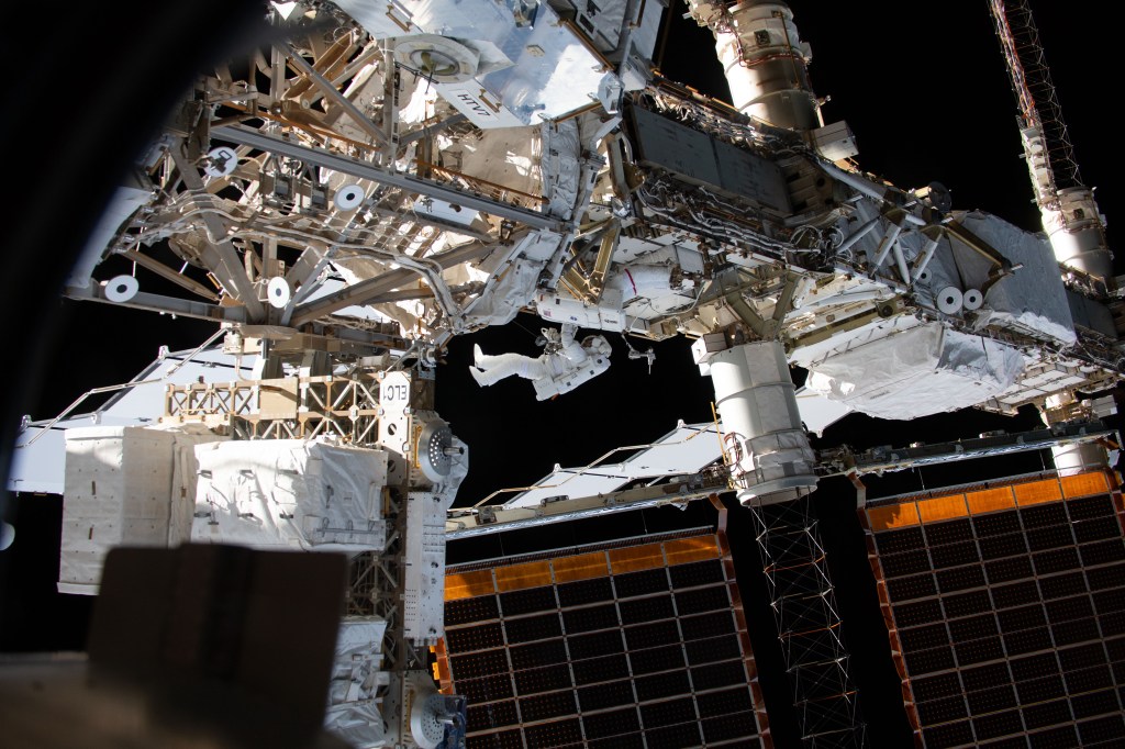Expedition 59 Flight Engineers Anne McClain of NASA (red stripes) and David Saint-Jacques of the Canadian Space Agency are seen while working outside the International Space Station. In a six and a half hour spacewalk, McClain and Saint-Jacques successfully established a redundant path of power to the Canadian-built robotic arm, known as Canadarm2, and installed cables to provide for more expansive wireless communications coverage outside the orbital complex, as well as for enhanced hardwired computer network capability. The duo also relocated an adapter plate from the first spacewalk in preparation for future battery upgrade operations.