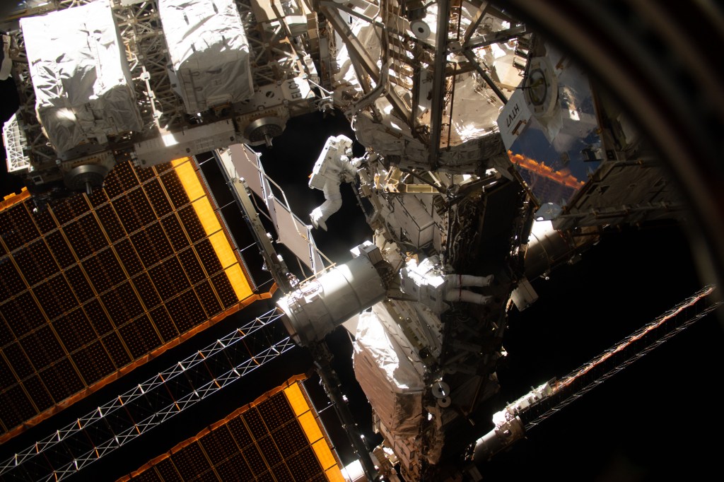 Expedition 59 Flight Engineers Anne McClain of NASA (red stripes, right) and David Saint-Jacques (no stripes, left) of the Canadian Space Agency are seen while working outside the International Space Station. In a six and a half hour spacewalk, McClain and Saint-Jacques successfully established a redundant path of power to the Canadian-built robotic arm, known as Canadarm2, and installed cables to provide for more expansive wireless communications coverage outside the orbital complex, as well as for enhanced hardwired computer network capability. The duo also relocated an adapter plate from the first spacewalk in preparation for future battery upgrade operations.