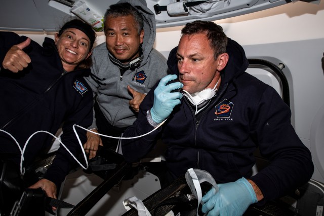 iss068e012319 (Oct. 6, 2022) --- SpaceX Crew-5 members (from left) Nicole Mann of NASA, Koichi Wakata of the Japan Aerospace Exploration Agency (JAXA), and Josh Cassada of NASA are pictured aboard the Dragon Endurance crew ship during a flight to the International Space Station.