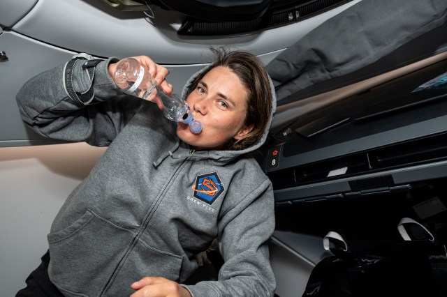 iss068e012328 (Oct. 6, 2022) --- SpaceX Crew-5 Mission Specialist Anna Kikina of Roscosmos drinks from a water bottle aboard the Dragon Endurance crew ship during a flight to the International Space Station.
