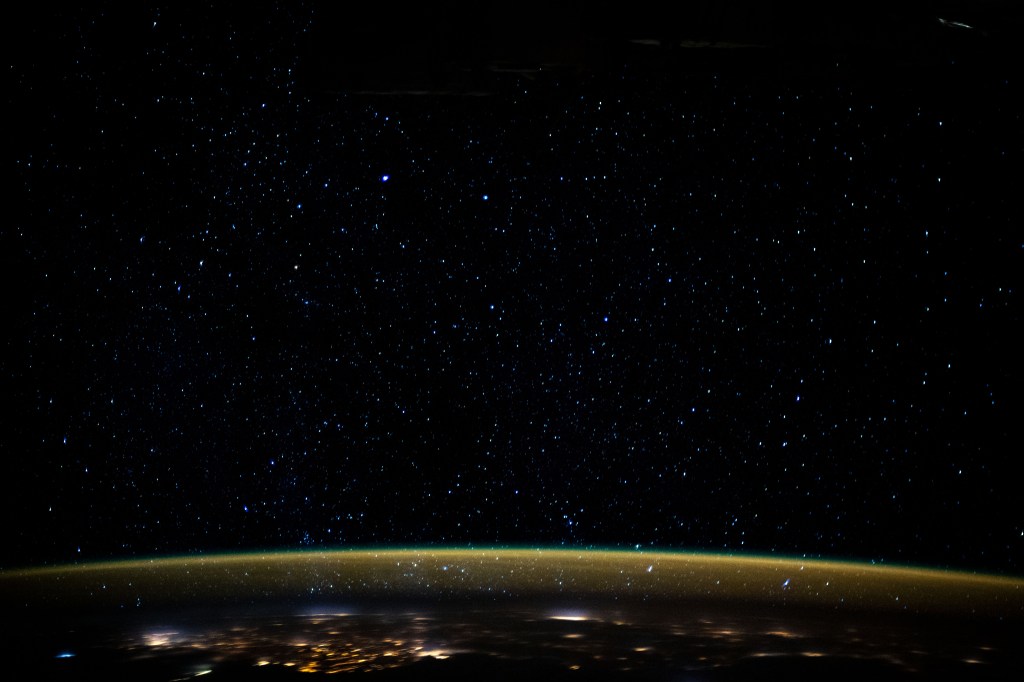 Stars glitter in the night sky above an atmospheric glow that blankets the city lights as the International Space Station orbited 259 miles above the Sudanese/Egyptian border before it crossed the Red Sea.