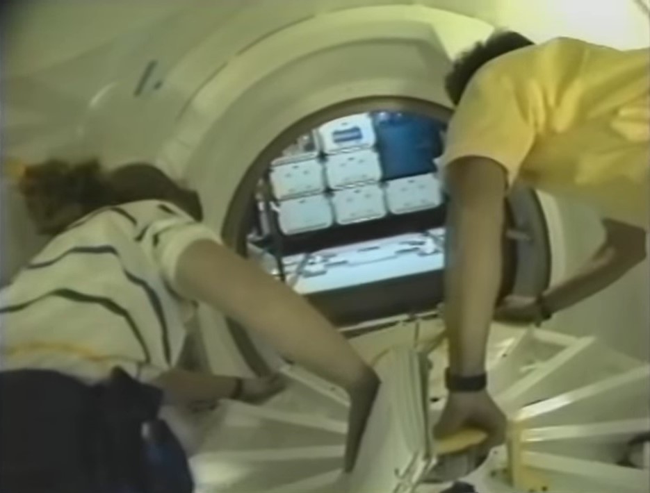 Astronauts N. Jan Davis, left, and Franklin R. Chang-Díaz open the hatch to the Spacehab module