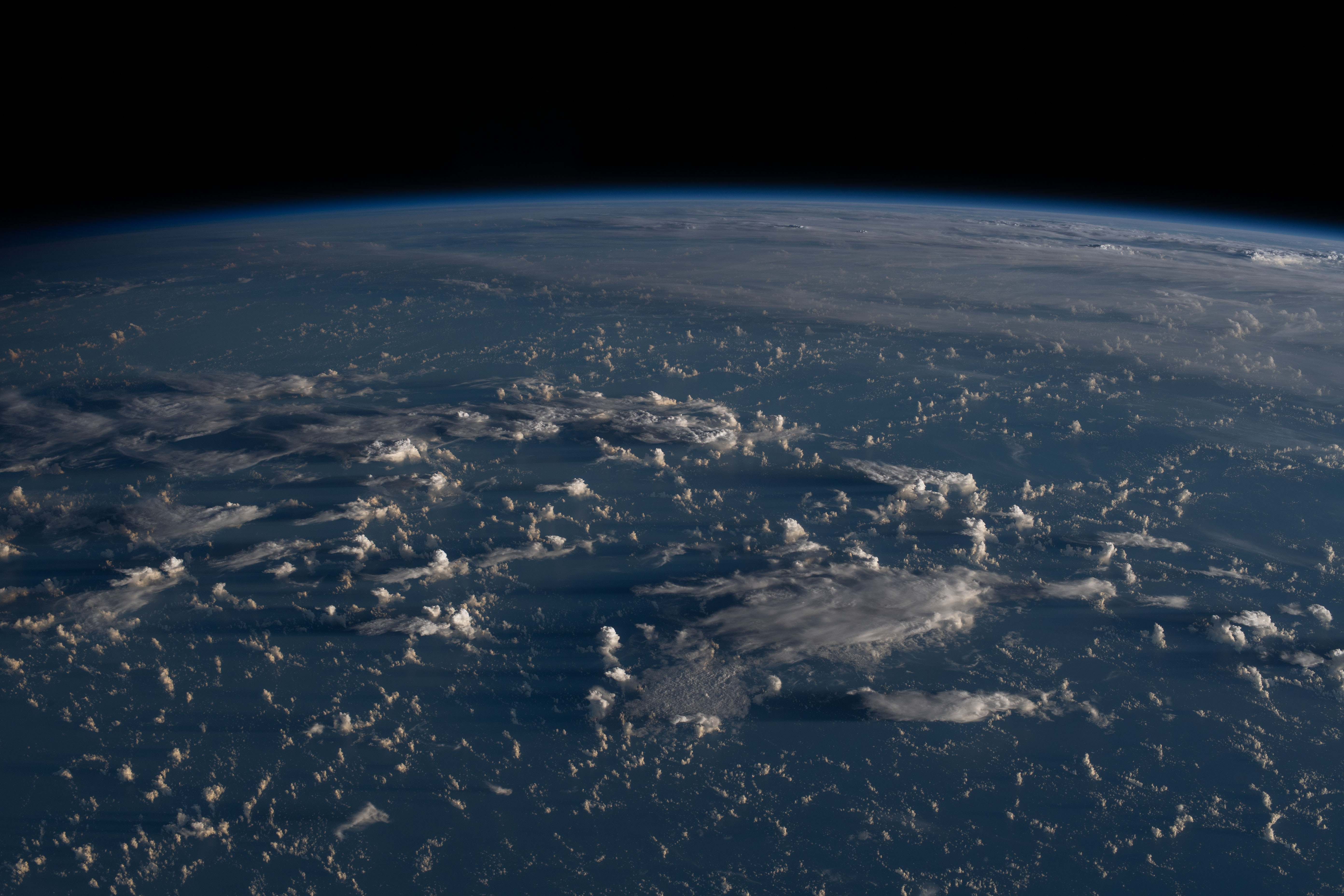 Sunrise casts long shadows from the clouds across the Philippine Sea as the International Space Station orbited about 200 miles east of Taiwan.