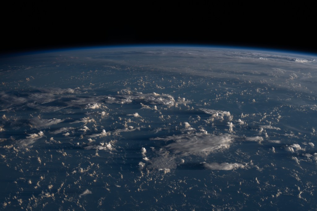 Sunrise casts long shadows from the clouds across the Philippine Sea as the International Space Station orbited about 200 miles east of Taiwan.