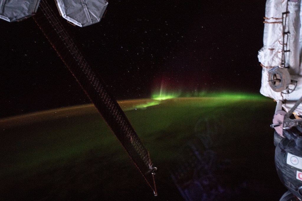 The aurora australis, also known as the "southern lights", is pictured as the International Space Station orbited 265 miles above the Indian Ocean southwest of Australia. Portions of the orbital complex can be seen including (from left) a pair of high-pressure gas tanks, solar arrays and the Soyuz MS-12 crew ship docked to the Rassvet module.