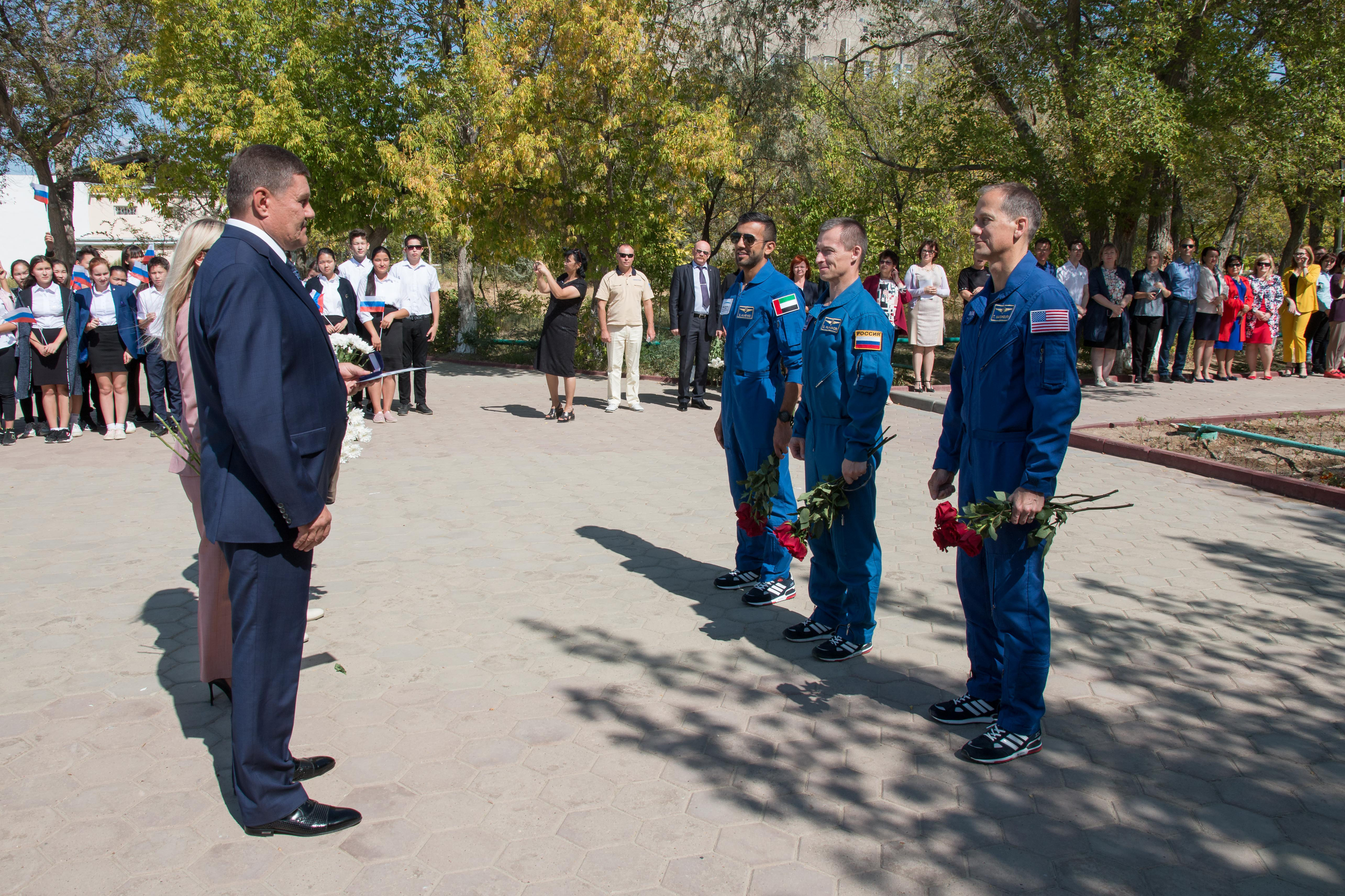 At their Cosmonaut Hotel crew quarters in Baikonur, Kazakhstan, the backup crewmembers for the next launch to the International Space Station meet with local Kazakh officials Sept. 12 as part of traditional pre-launch activities. On the right are backup spaceflight participant Sultan Al-Neyadi of the United Arab Emirates, Sergey Ryzhikov of Roscosmos and Tom Marshburn of NASA. They are the backups to the prime Expedition 61 crew, Oleg Skripochka of Roscosmos and Jessica Meir of NASA and spaceflight participant Hazzaa Ali Almansoori of the United Arab Emirates, who will launch Sept. 25 on the Soyuz MS-15 spacecraft for a mission on the International Space Station.
