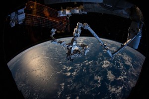 The Canadarm2 robotic arm with the Dextre robotic hand attached seemingly protrudes from the side of the International Space Station as the orbiting complex soared 263 miles above the South Pacific Ocean.