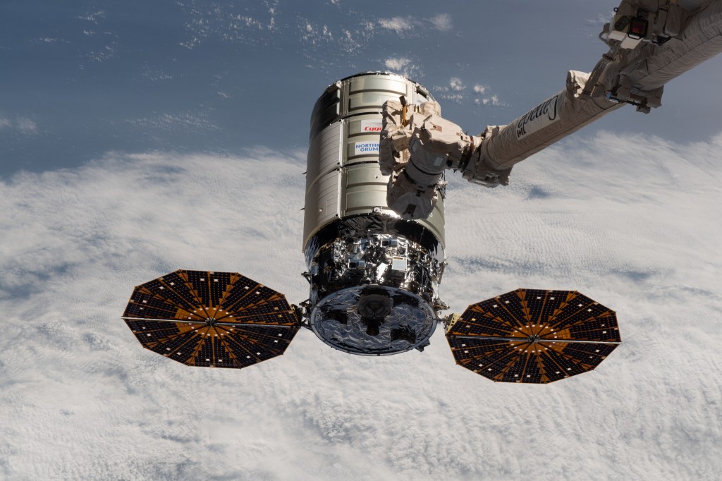 The Northrop Grumman Cygnus space freighter approaches the International Space Station as the Canadarm2 robotic arm is poised to reach out and capture the cargo vehicle.