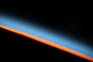 The first rays of an orbital sunrise shine illuminates the Earth's limb and highlights the atmosphere as the International Space Station orbits 259 miles above the central United States.