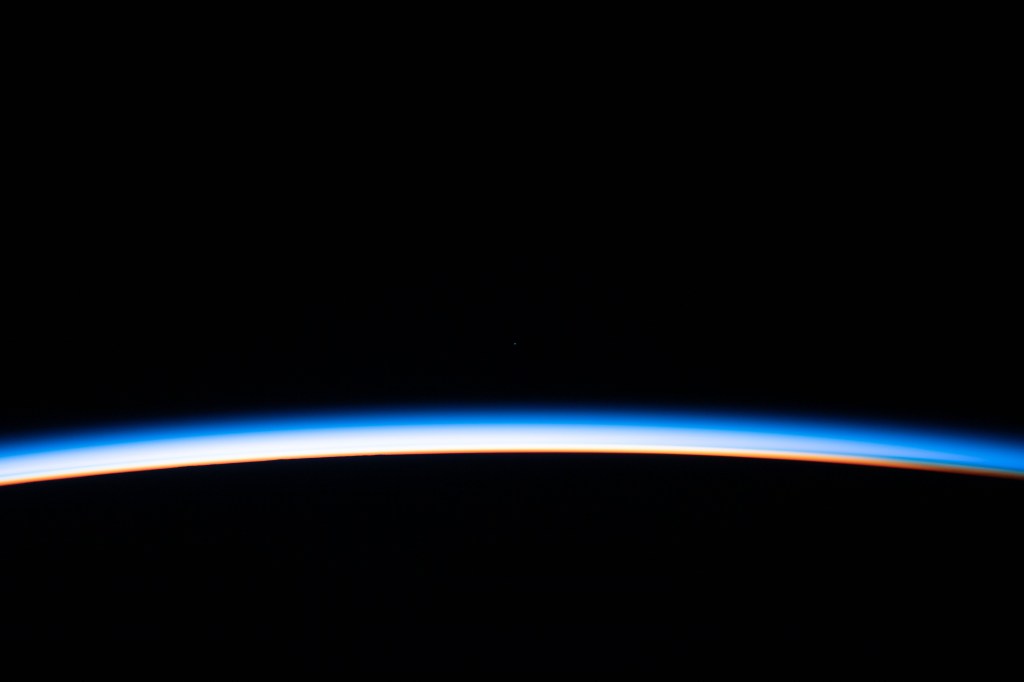 The first rays of an orbital sunrise illuminates the Earth's limb and highlights the atmosphere as the International Space Station orbits 260 miles above the Atlantic Ocean.