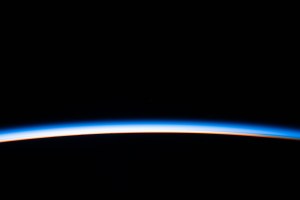 The first rays of an orbital sunrise illuminates the Earth's limb and highlights the atmosphere as the International Space Station orbits 260 miles above the Atlantic Ocean.