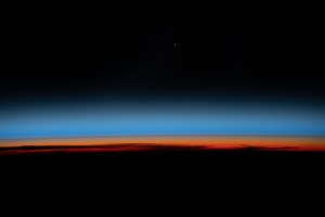 The first rays of an orbital sunrise shine illuminates the Earth's limb and highlights the atmosphere as the International Space Station orbits 259 miles above the central United States.