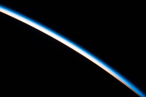 The first rays of an orbital sunrise illuminates the Earth's limb and highlights the atmosphere as the International Space Station orbits 260 miles above the Atlantic Ocean.