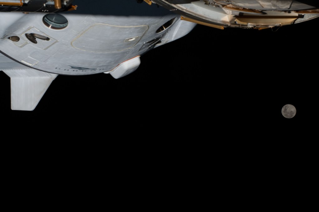 iss068e039227 (Jan. 6, 2023) --- The Full Moon is pictured from the International Space Station along with a portion the SpaceX Dragon Endurance crew ship while orbiting 264 miles above southern Brazil.