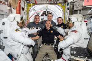 The International Space Station Expedition 61 crew pauses for a photo as NASA Astronauts Jessica Meir and Christina Koch prepare to exit the space station to begin the first all female spacewalk in history on Oct. 18, 2019. The astronauts replaced a faulty battery charge discharge unit (BCDU) that failed to activate following the Oct. 11 installation of new lithium ion batteries on the space station's exterior structure. The BCDUs regulate the amount of charge put into the batteries that collect energy from the station's solar arrays to power station systems during periods when the station orbits during nighttime passes around Earth. Though the BCDU failure has not impacted station operations or crew safety, it does prevent the new batteries from providing increased station power.