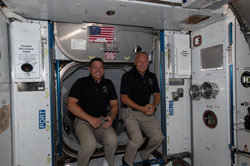 The International Space Station's two newest crew members, NASA astronauts (from left) Bob Behnken and Doug Hurley, are pictured having just entered the orbiting lab shortly after arriving aboard the SpaceX Crew Dragon spacecraft.