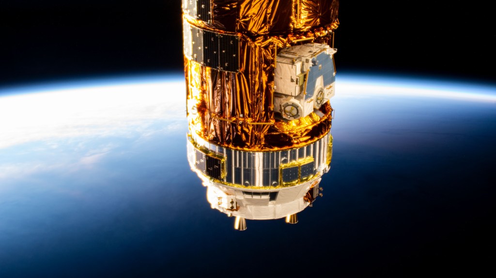 The Kounotori H-II Transfer Vehicle 8 (HTV-8) from the Japan Aerospace Exploration Agency is pictured attached to the International Space Station's Harmony module (out of frame) as the orbiting complex flies into an orbital sunrise.