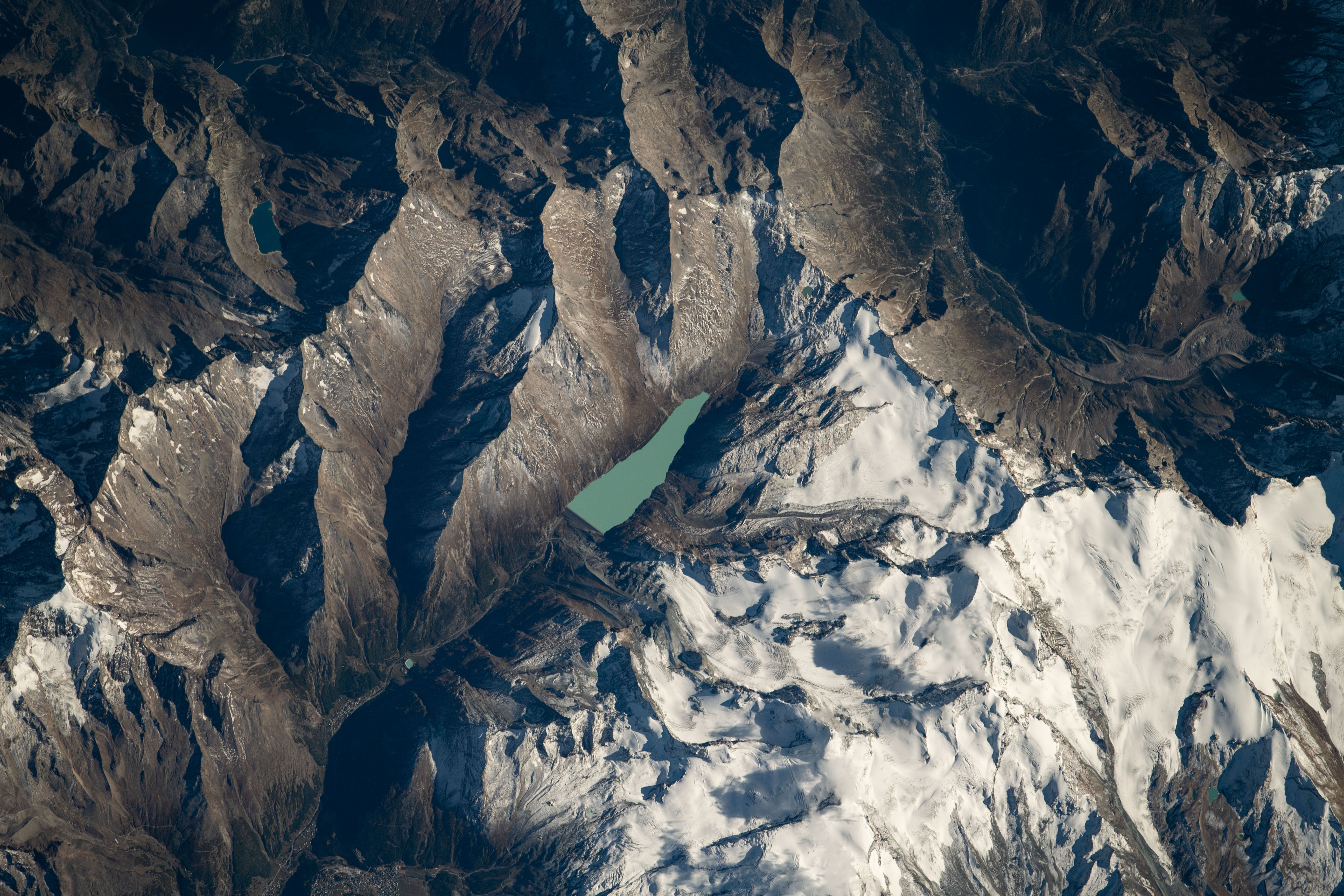 The Mattmarksee, a reservoir built in the early 1960's between the Rimpfischhorn and Stellihorn mountains in the Swiss Alps, was photographed from the International Space Station at an altitude of 253 miles above Switzerland.