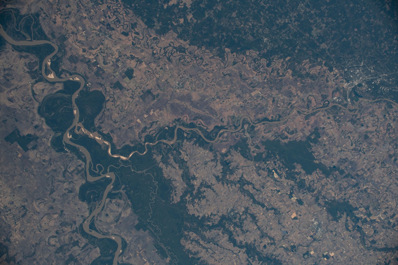 The Mississippi River separates the states of Mississippi and Arkansas and splits into the Arkansas River. The International Space Station was orbiting 255 miles in altitude and 164 miles west of Memphis, Tennessee, when this photograph was taken.