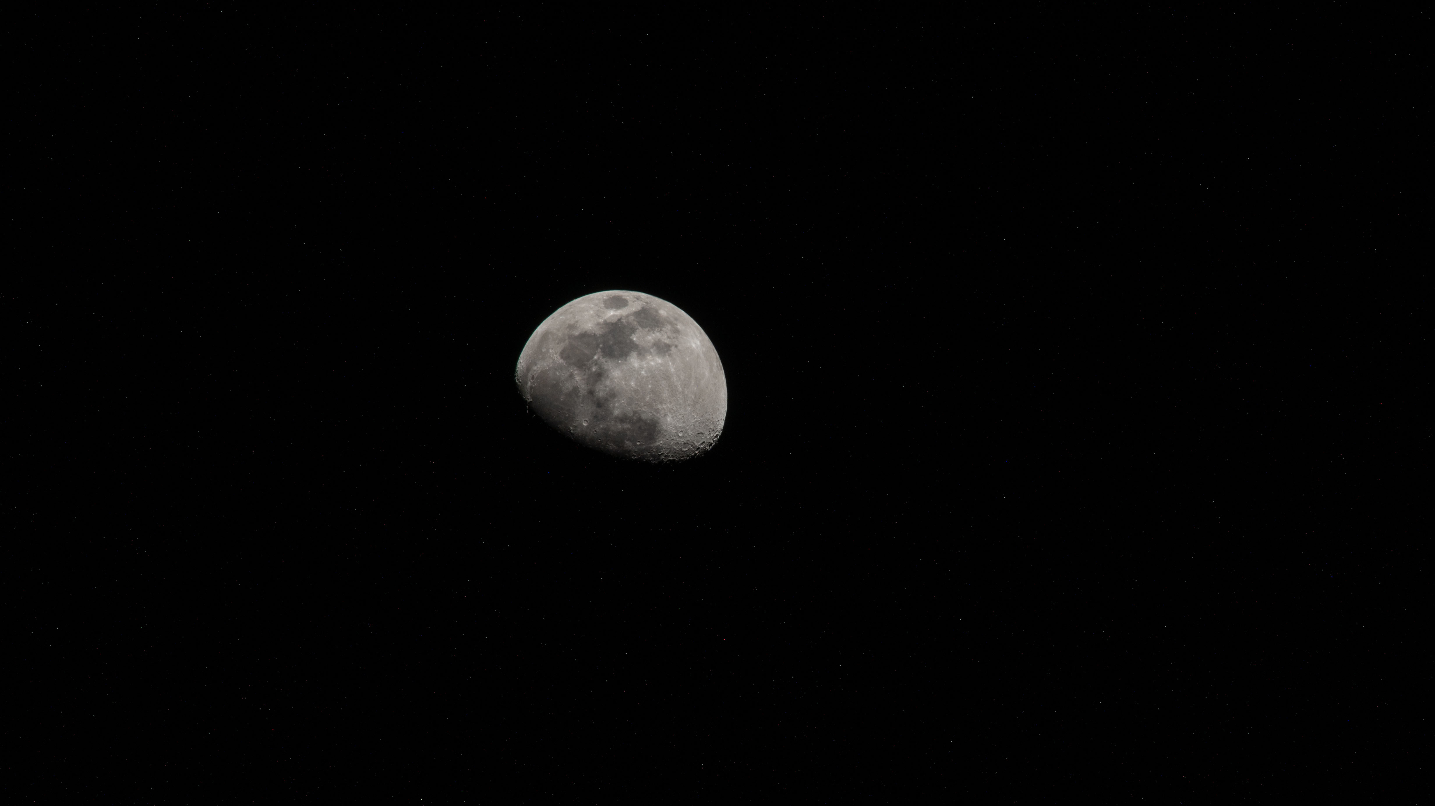 The moon is photographed in its waxing gibbous phase as the International Space Station orbited 256 miles above the North Pacific Ocean south of Alaska's Aleutian Islands.