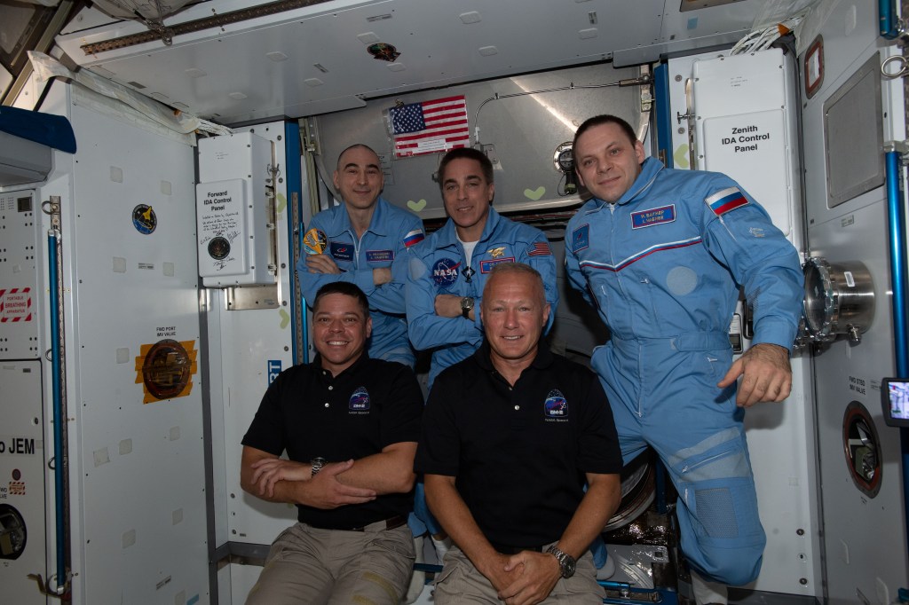 The newly-expanded Expedition 63 crew with NASA astronauts (front row, from left) Bob Behnken and Doug Hurley having just entered the International Space Station shortly after arriving aboard the SpaceX Crew Dragon spacecraft. In the center, in the back row, is NASA Commander Chris Cassidy flanked by Roscosmos Flight Engineers (from left) Anatoly Ivanishin and Ivan Vagner.
