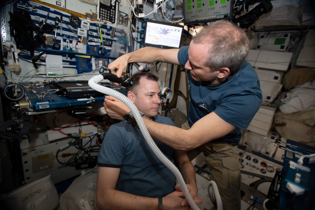 The orbital lab becomes a high-flying hair salon as David Saint-Jacques of the Canadian Space Agency trims NASA astronaut Nick Hague’s hair aboard the International Space Station.