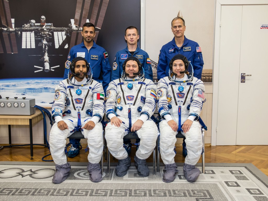 In the Integration Building at the Baikonur Cosmodrome in Kazakhstan, the prime and backup crewmembers for the next launch to the International Space Station pose for pictures Sept. 11. In the front row from left to right are the prime crewmembers, spaceflight participant Hazzaa Ali Almansoori of the United Arab Emirates and Expedition 61 crewmembers Oleg Skripochka of Roscosmos and Jessica Meir of NASA. In the back row are their backups. From left to right are spaceflight participant Sultan Al-Neyadi of the United Arab Emirates, Sergey Ryzhikov of Roscosmos and Tom Marshburn of NASA. Almansoori, Skripochka and Meir will launch Sept. 25 on the Soyuz MS-15 spacecraft from the Baikonur Cosmodrome for a mission on the International Space Station.