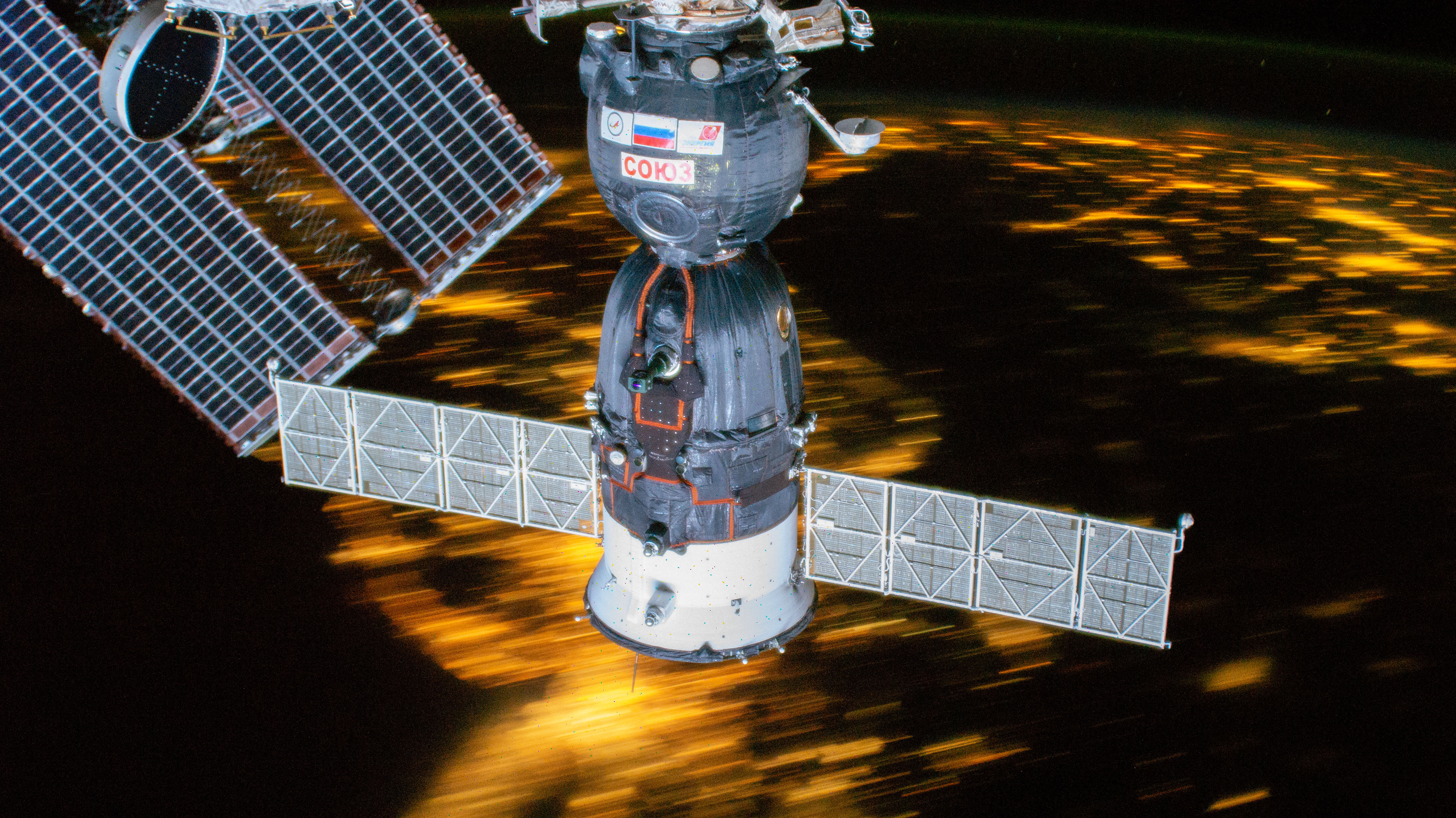 The recently-arrived Soyuz MS-12 spacecraft is pictured docked to the International Space Station as the orbital complex flew 255 miles above the northeast United States.