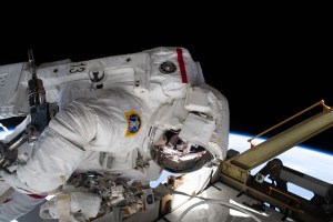 The reflection in NASA astronaut Jessica Meir's spacesuit helmet is fellow NASA astronaut Christina Koch photographing her crewmate during a spacewalk to finalize upgrading power systems on the International Space Station's Port-6 truss structure.