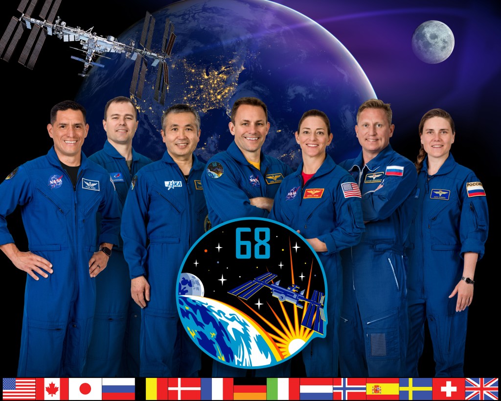 iss068-s-002 (Feb. 7, 2022) --- The seven-member Expedition 68 crew poses for an official portrait. From left are, NASA astronaut Frank Rubio; Roscosmos cosmonaut Dmitri Petelin; Japan Aerospace Exploration Agency (JAXA) astronaut Koichi Wakata; NASA astronauts Josh Cassada and Nicole Mann; and Roscosmos cosmonauts Sergey Prokopyev and Anna Kikina.