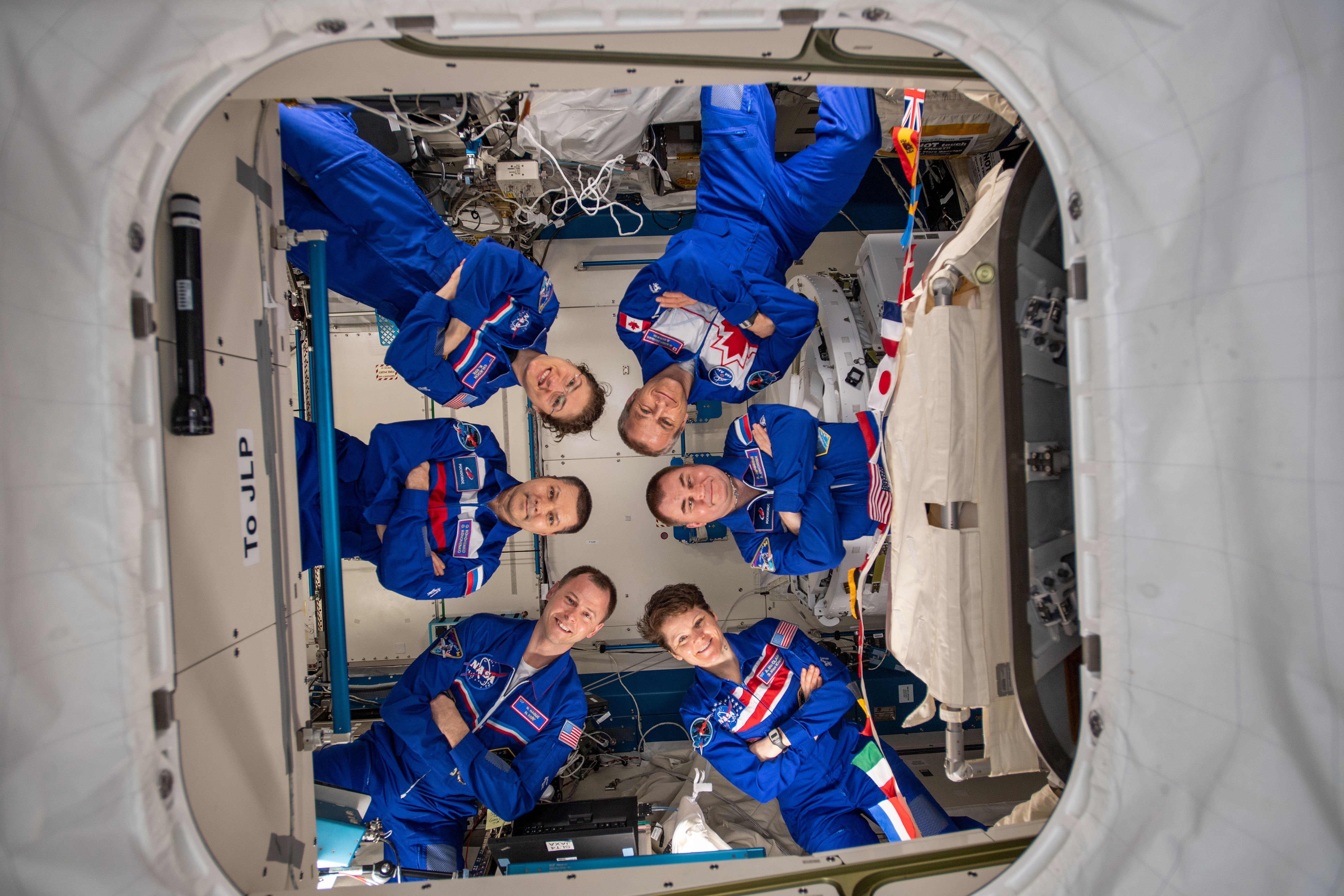 The six-member Expedition 59 crew gathers for a portrait aboard the International Space Station. Clockwise from center left are, Commander Oleg Kononenko and Flight Engineers Christina Koch, David Saint-Jacques, Alexey Ovchinin, Anne McClain and Nick Hague.