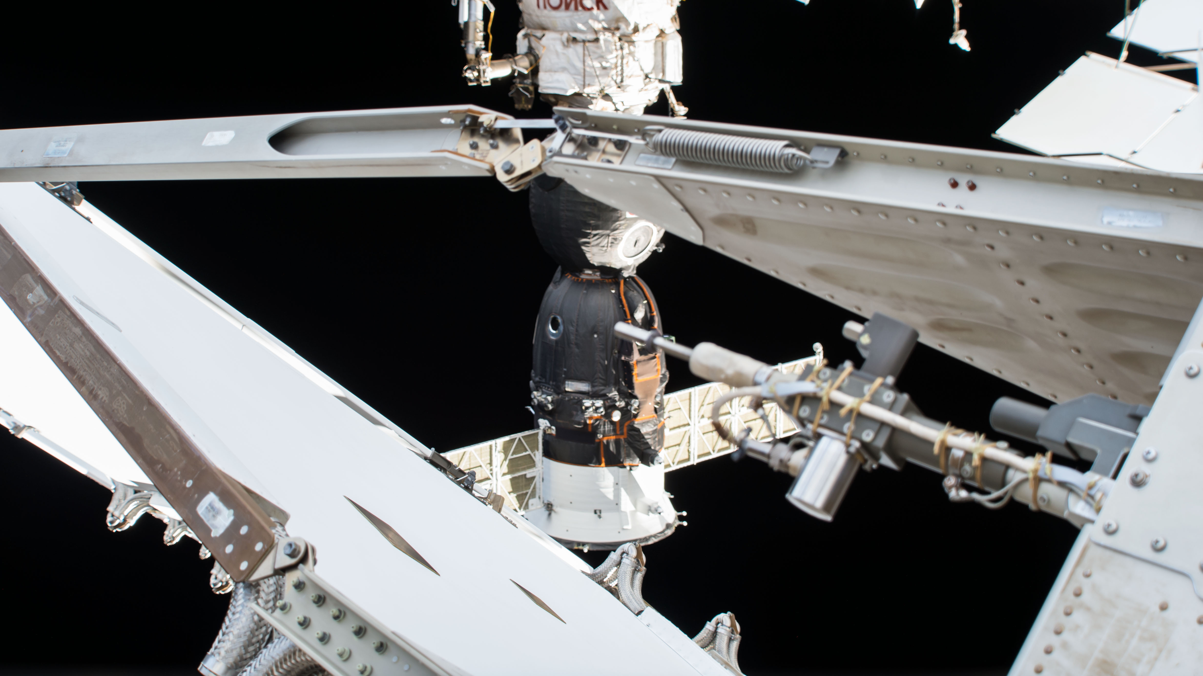 The Soyuz MS-11 spacecraft docked to the Poisk module is pictured from a ground-controlled external high definition camera. The Soyuz crew ship arrived at the International Space Station Dec. 3 with three new crewmembers including Soyuz Commander Oleg Kononenko and Flight Engineers Anne McClain and David Saint-Jacques. It will return the same three crewmembers to a parachute-assisted landing in Kazakhstan on June 24.