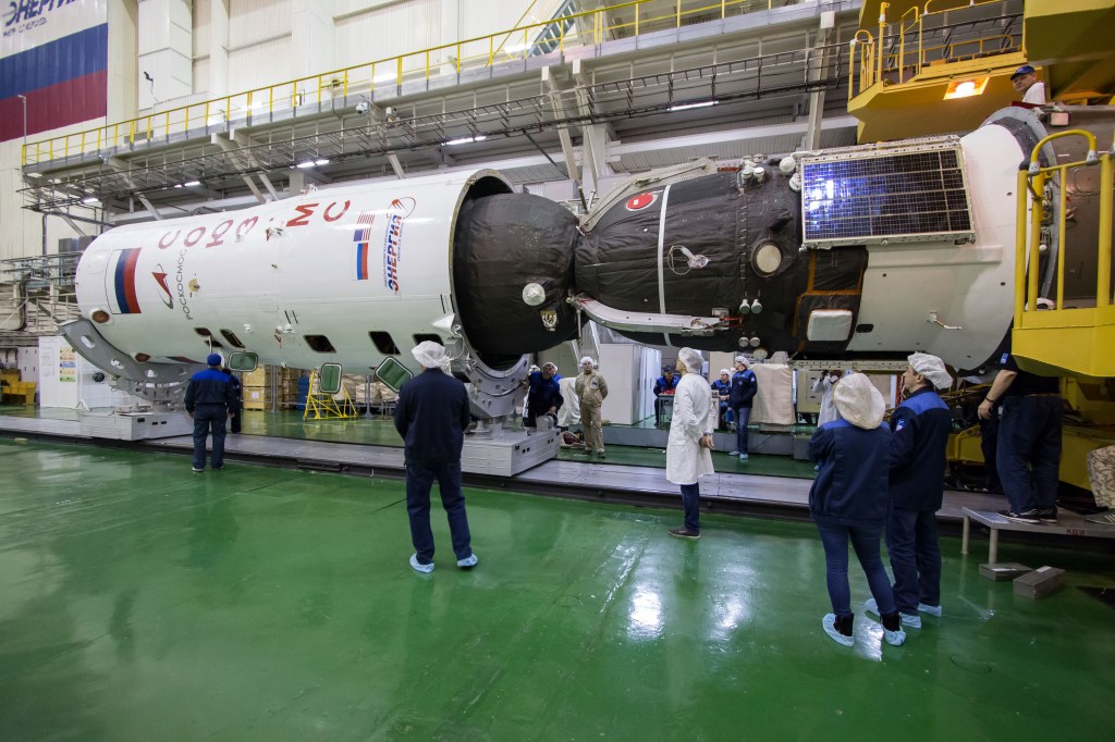 In the Integration Building at the Baikonur Cosmodrome in Kazakhstan, the Soyuz MS-12 spacecraft is encapsulated into the nose fairing of the Soyuz booster rocket March 6. Expedition 59 crew members Nick Hague and Christina Koch of NASA and Alexey Ovchinin of Roscosmos will launch on March 14, U.S. time, on the Soyuz MS-12 spacecraft from the Baikonur Cosmodrome for a six-and-a-half month mission on the International Space Station.