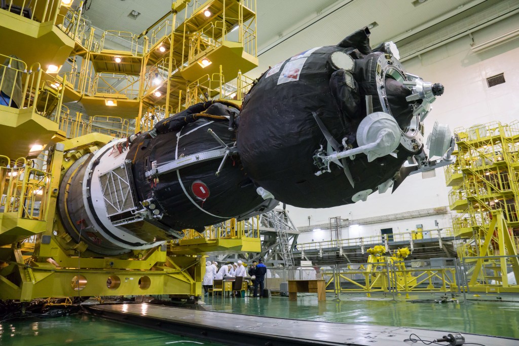 In the Integration Building at the Baikonur Cosmodrome in Kazakhstan, the Soyuz MS-12 spacecraft is lowered into position March 6 prior to its encapsulation into the nose fairing of the Soyuz booster rocket. Expedition 59 crew members Nick Hague and Christina Koch of NASA and Alexey Ovchinin of Roscosmos will launch on March 14, U.S. time, on the Soyuz MS-12 spacecraft from the Baikonur Cosmodrome for a six-and-a-half month mission on the International Space Station.