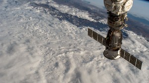 The Soyuz MS-21 crew ship is pictured attached to the Prichal docking module as the International Space Station orbited 260 miles above a cloudy Peru on the South American continent.